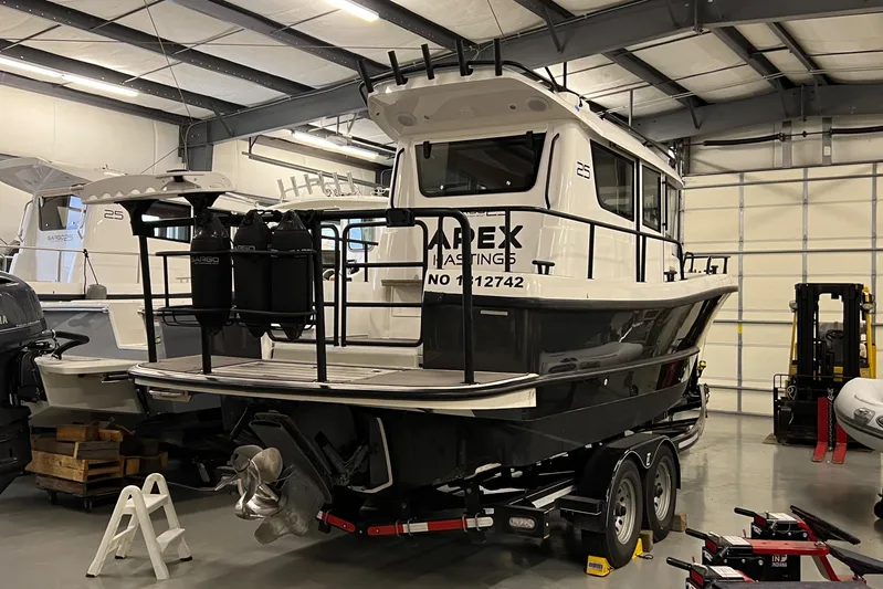  Yacht Photos Pics 2021 Sargo 25 boat on trailer in indoor storage facility.