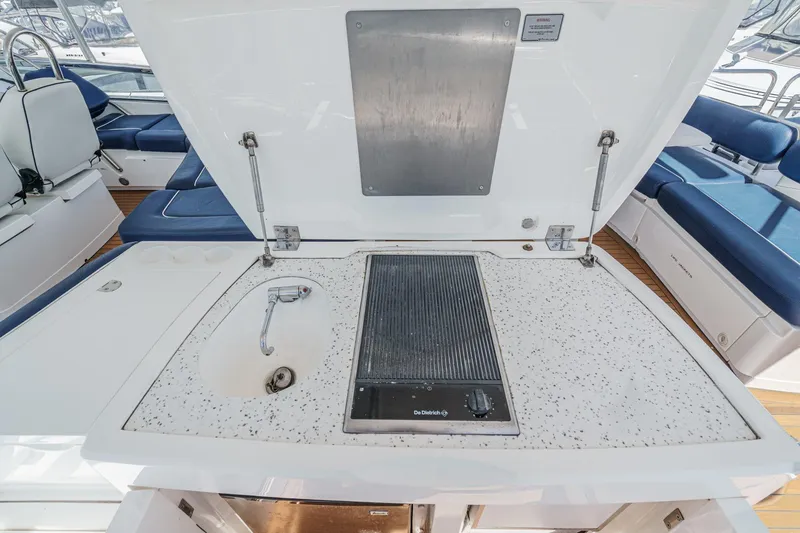 Compass Rose Yacht Photos Pics Outdoor kitchen area on 2006 Fairline 74 Custom yacht with sink and grill.