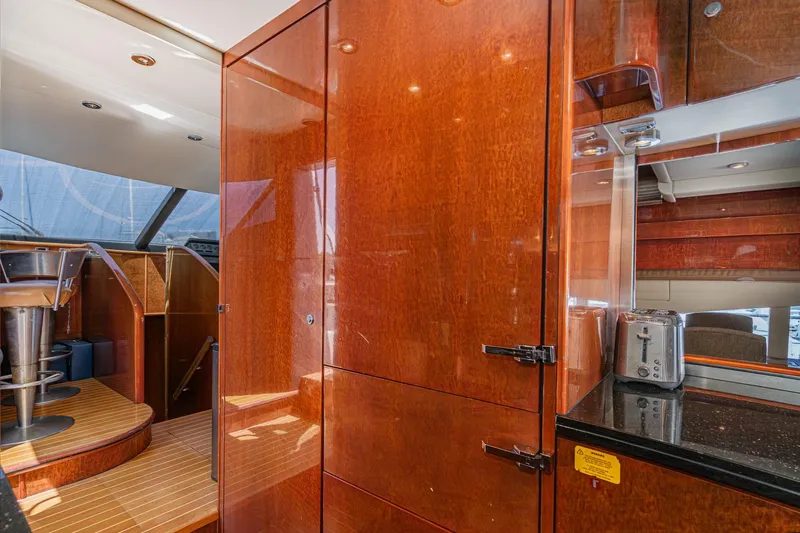 Compass Rose Yacht Photos Pics Luxurious interior of 2006 Fairline 74 Custom yacht with polished wood and modern amenities.