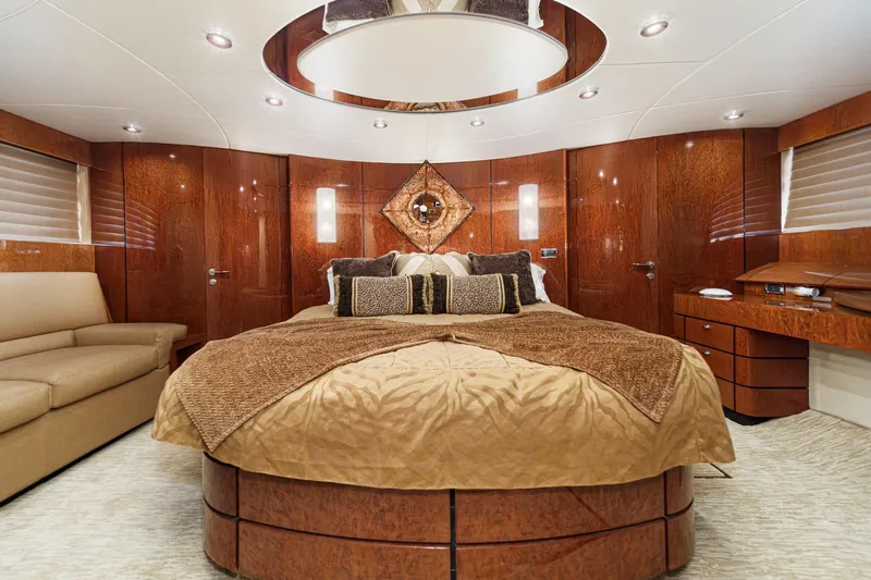 Compass Rose Yacht Photos Pics Luxurious 2006 Fairline 74 Custom yacht bedroom with elegant wood paneling and plush bedding.