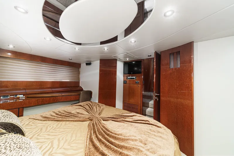 Compass Rose Yacht Photos Pics Luxurious interior of 2006 Fairline 74 Custom yacht bedroom with elegant wood finishes.