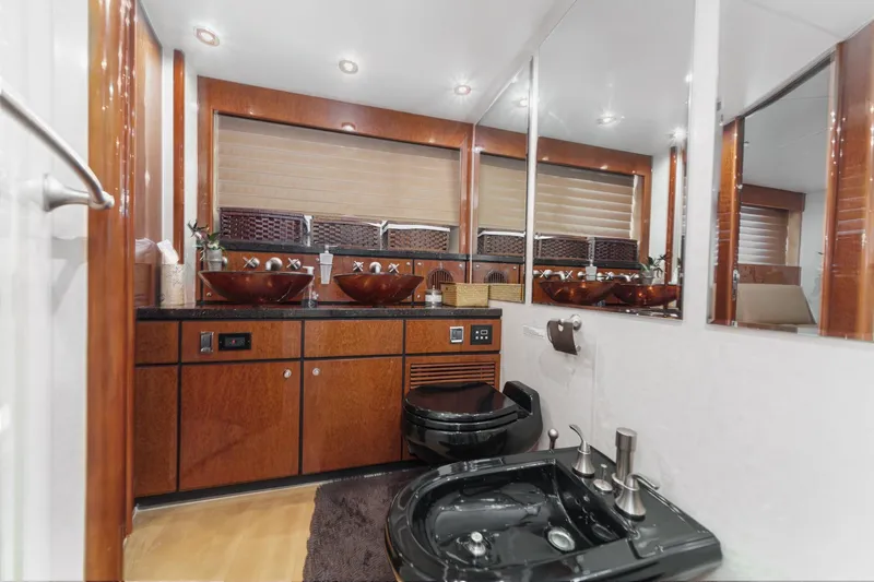 Compass Rose Yacht Photos Pics Luxurious bathroom in 2006 Fairline 74 Custom yacht with elegant wood finishes and modern fixtures.