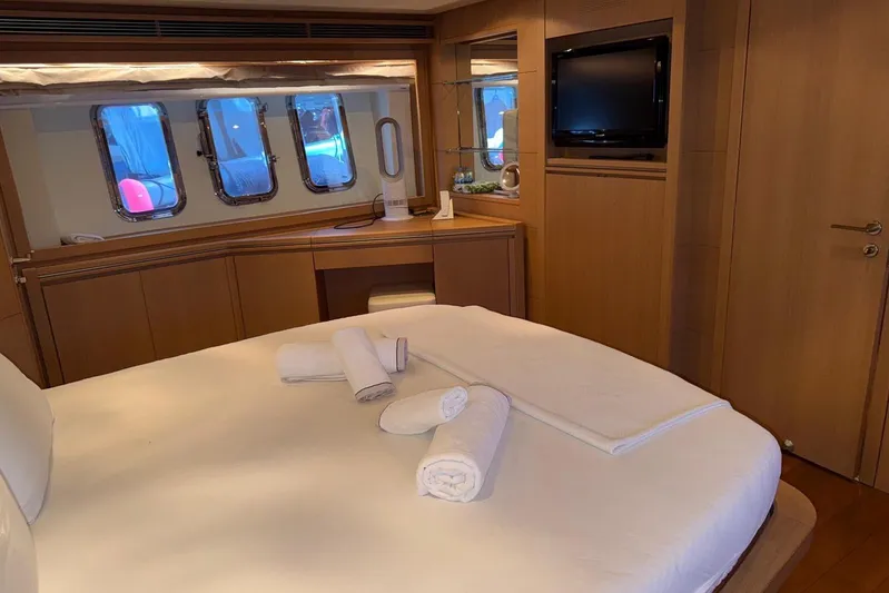  Yacht Photos Pics Luxurious bedroom interior of 2008 Evo Marine Deauville 76 yacht with elegant wood finishes.