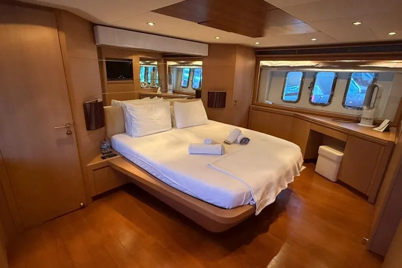  Yacht Photos Pics Luxurious bedroom interior of 2008 Evo Marine Deauville 76 yacht with elegant wood finishes.