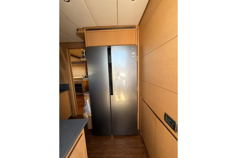  Yacht Photos Pics Modern kitchen interior on 2008 Evo Marine Deauville 76 yacht, featuring sleek refrigerator.