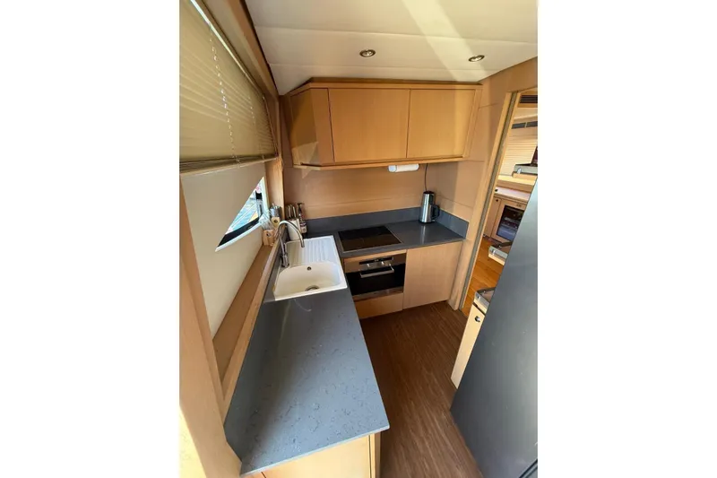  Yacht Photos Pics Compact kitchen in 2008 Evo Marine Deauville 76 yacht with modern appliances and sleek design.