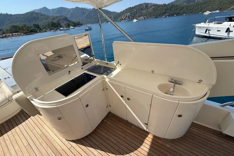  Yacht Photos Pics Outdoor kitchen on 2008 Evo Marine Deauville 76 yacht, featuring stove and sink, with scenic ocean view.