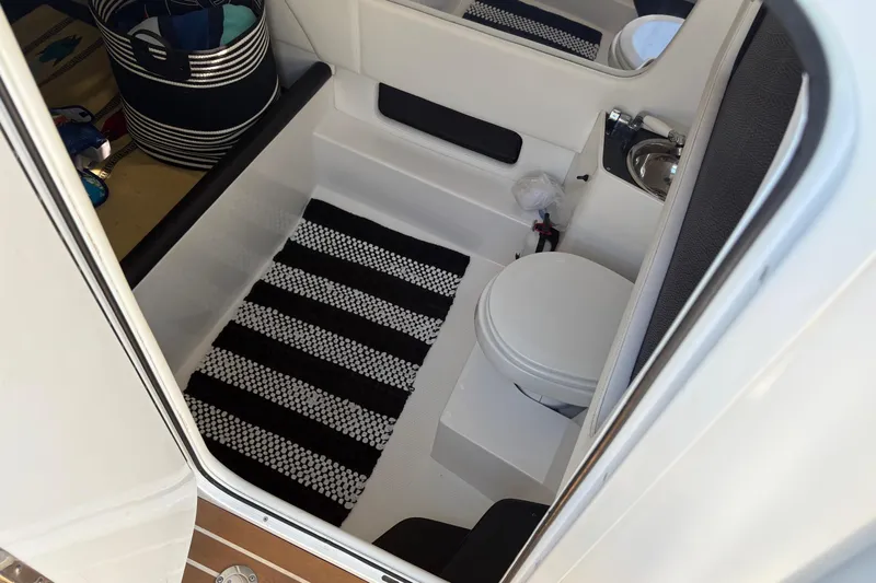  Yacht Photos Pics Interior of 2012 Nor-Tech 340 Sport Center Console boat with toilet and striped rug.