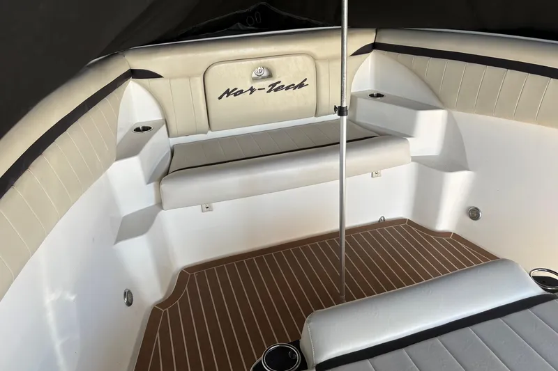  Yacht Photos Pics 2012 Nor-Tech 340 Sport Center Console interior with beige seating and wood-patterned flooring.