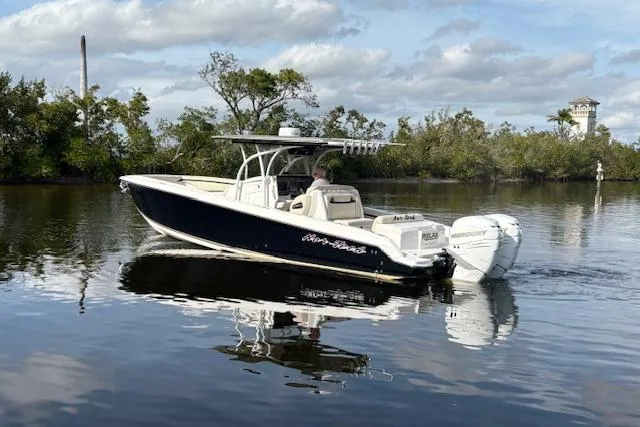  Yacht Photos Pics 2012 Nor-Tech 340 Sport Center Console boat on calm water, surrounded by trees.