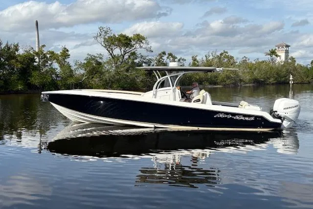 Yacht Photos Pics 2012 Nor-Tech 340 Sport Center Console boat on calm water, surrounded by trees.