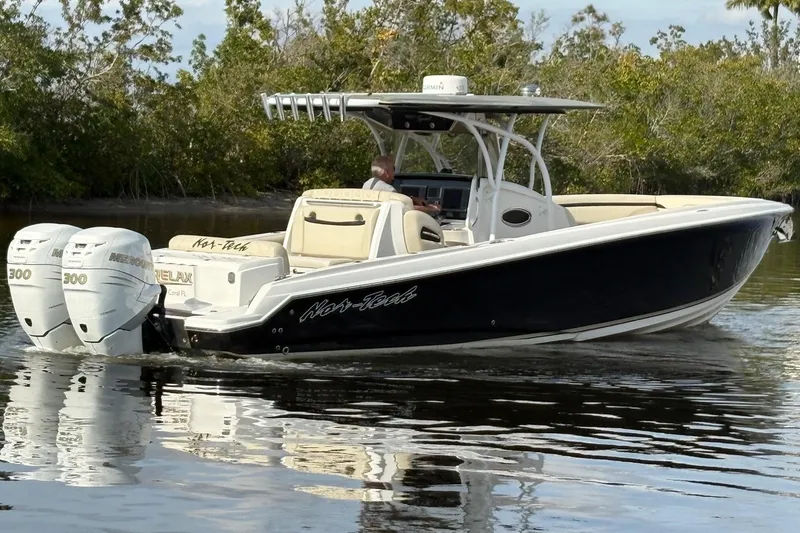  Yacht Photos Pics 2012 Nor-Tech 340 Sport Center Console boat cruising on calm water.