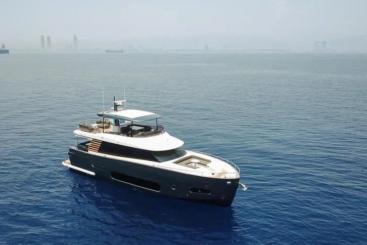 Grey T Yacht Photos Pics Azimut Magellano 66 yacht, 2021 model, cruising on calm blue waters.