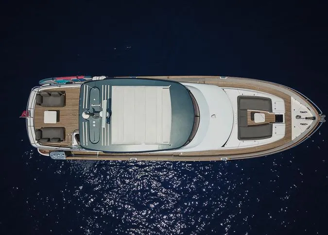 Grey T Yacht Photos Pics Aerial view of 2021 Azimut Magellano 66 yacht on dark blue water.