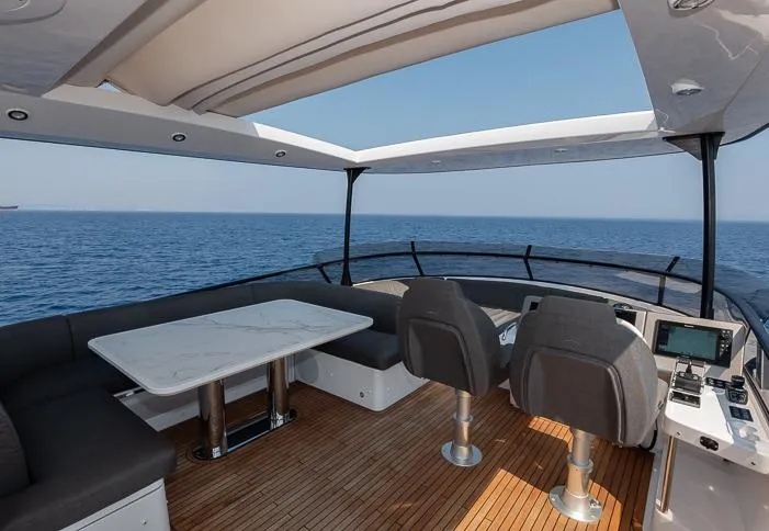 Grey T Yacht Photos Pics Luxurious 2021 Azimut Magellano 66 yacht deck with seating and ocean view.