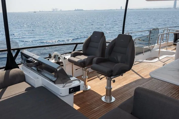 Grey T Yacht Photos Pics Flybridge of 2021 Azimut Magellano 66 yacht with dual helm seats and ocean view.