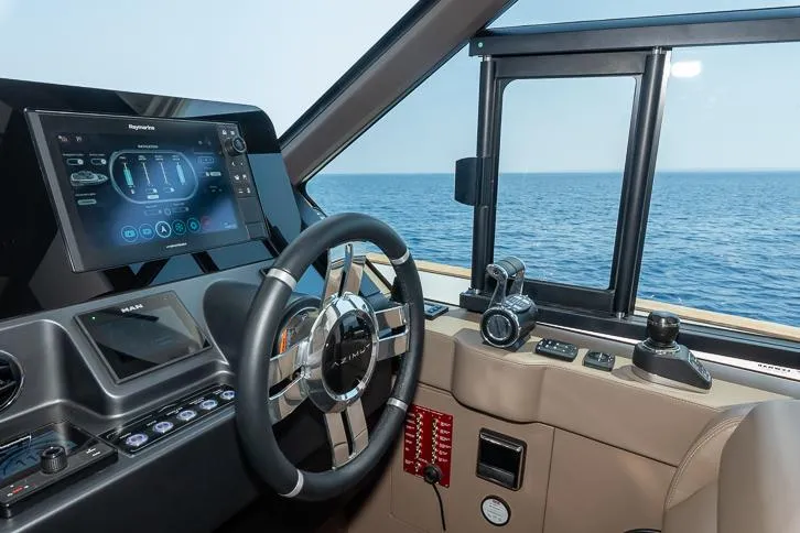 Grey T Yacht Photos Pics Helm of 2021 Azimut Magellano 66 yacht with modern navigation controls.