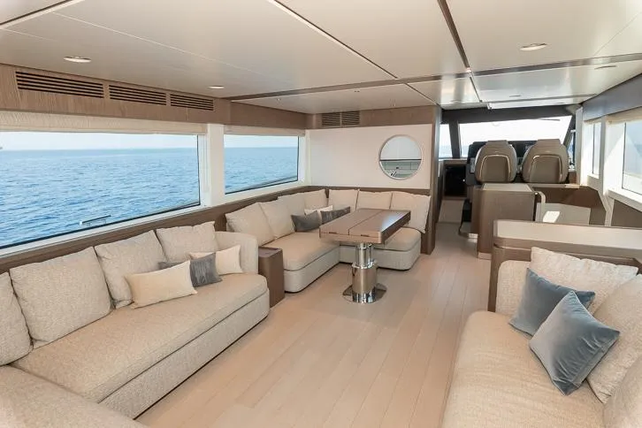Grey T Yacht Photos Pics Luxurious interior of 2021 Azimut Magellano 66 yacht with elegant seating and ocean view.