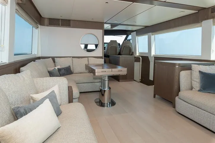 Grey T Yacht Photos Pics Luxurious interior of 2021 Azimut Magellano 66 yacht with modern seating and large windows.