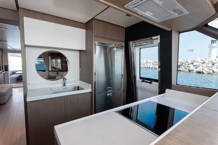 Grey T Yacht Photos Pics Modern kitchen interior of 2021 Azimut Magellano 66 yacht with ocean view.