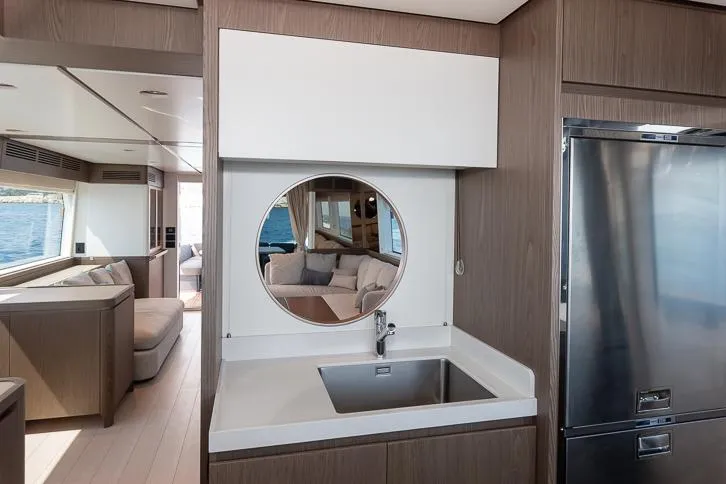 Grey T Yacht Photos Pics Interior of 2021 Azimut Magellano 66 yacht, featuring modern kitchen and living area.