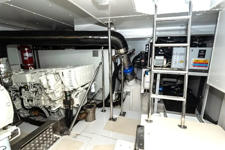 Grey T Yacht Photos Pics Engine room of 2021 Azimut Magellano 66 yacht, featuring modern equipment and ladder access.