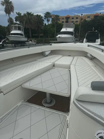  Yacht Photos Pics 2017 HCB Suenos boat interior with white seating and table, docked at marina.