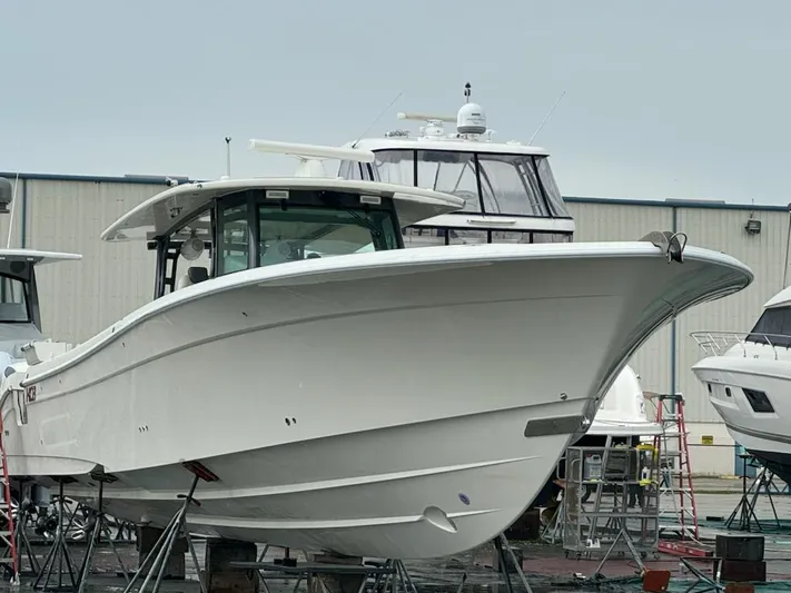  Yacht Photos Pics 2017 HCB Suenos boat in a shipyard, surrounded by other vessels.