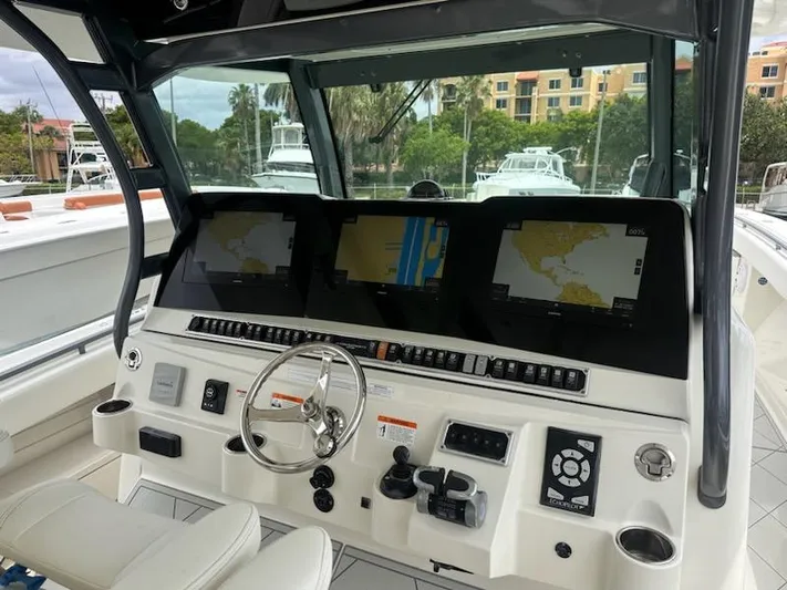  Yacht Photos Pics 2017 HCB Suenos boat dashboard with navigation screens and steering wheel.
