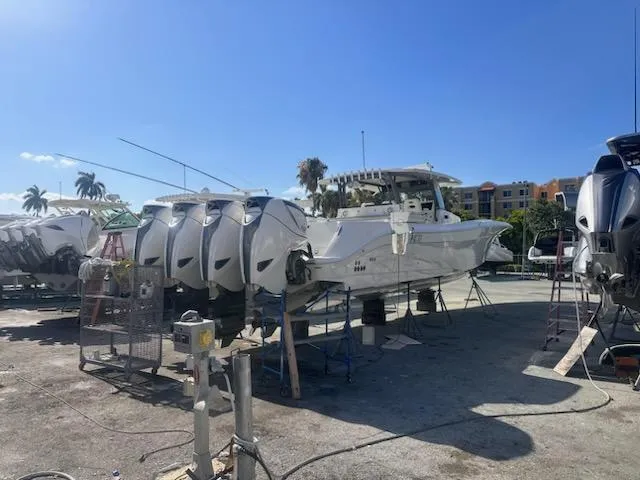  Yacht Photos Pics 2017 HCB Suenos boat with multiple outboard engines in a sunny marina.