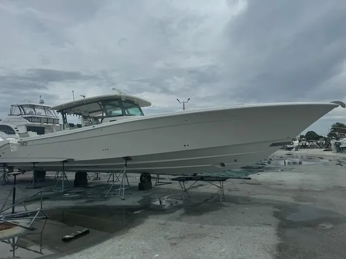  Yacht Photos Pics 2017 HCB Suenos boat on stands in a marina under cloudy skies.