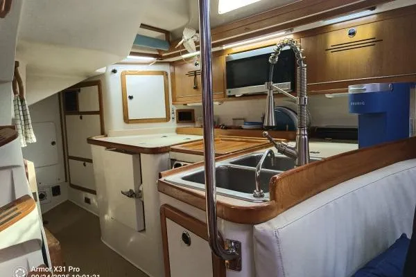 Mandala Yacht Photos Pics Interior of 2002 Catalina 42 MkII sailboat, featuring a modern kitchen with wood accents.
