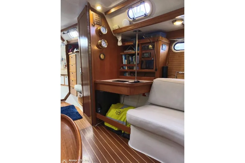 Mandala Yacht Photos Pics Interior of 2002 Catalina 42 MkII sailboat with wood finish and navigation station.