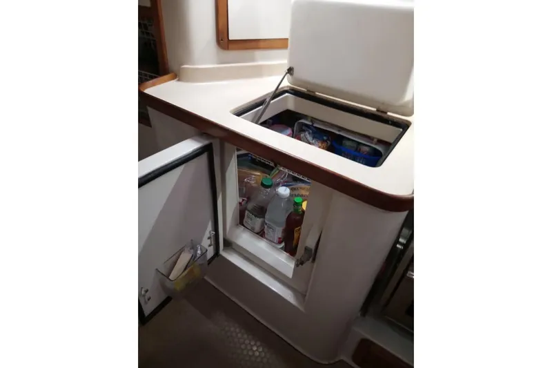 Mandala Yacht Photos Pics Interior of 2002 Catalina 42 MkII yacht with open fridge and storage.