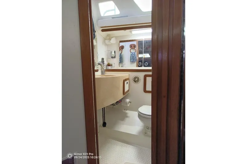 Mandala Yacht Photos Pics Bathroom interior of 2002 Catalina 42 MkII sailboat, featuring sink and toilet.