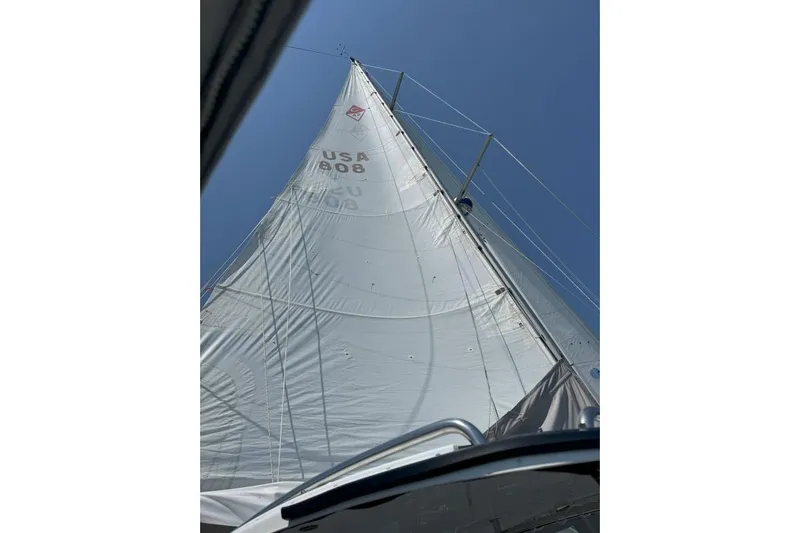 Mandala Yacht Photos Pics Sail of a 2002 Catalina 42 MkII yacht against a clear blue sky.