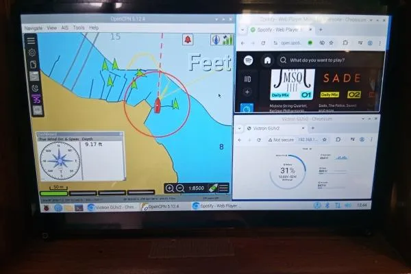 Mandala Yacht Photos Pics Navigation software on a Catalina 42 MkII sailboat's display, showing maps and music player.