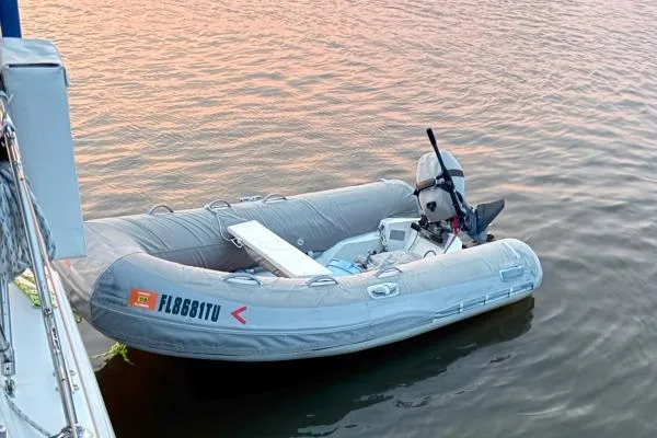 Mandala Yacht Photos Pics Inflatable dinghy with outboard motor floating beside a Catalina 42 MkII, 2002 model.