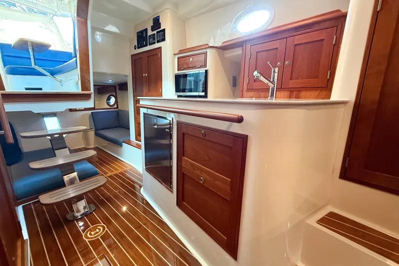  Yacht Photos Pics Luxurious interior of 2021 Hinckley Sport Boats 40x, featuring elegant wood finishes and modern amenities.