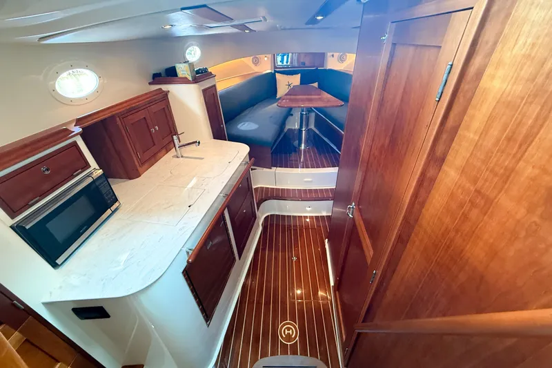  Yacht Photos Pics Interior of 2021 Hinckley Sport Boats 40x, featuring wood cabinetry and modern amenities.