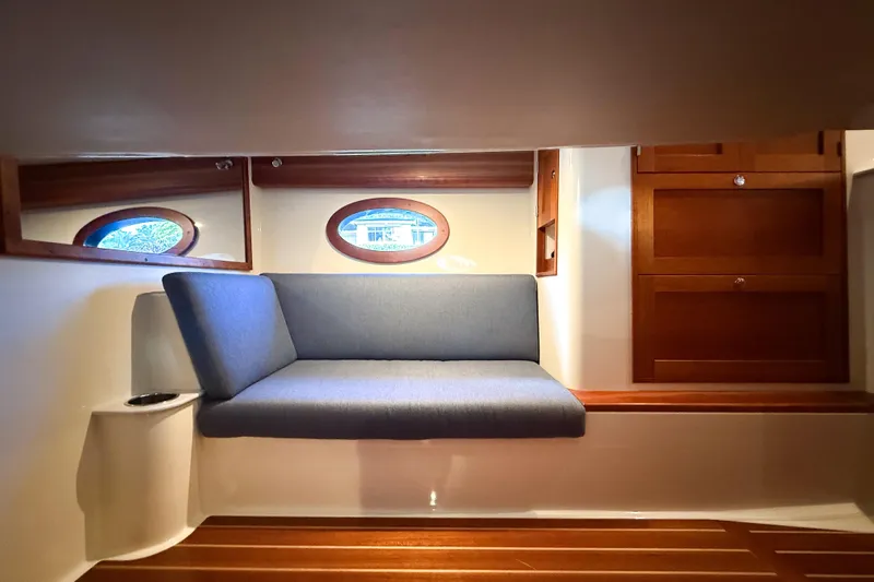  Yacht Photos Pics 2021 Hinckley Sport Boats 40x interior with blue seating and wooden cabinetry.
