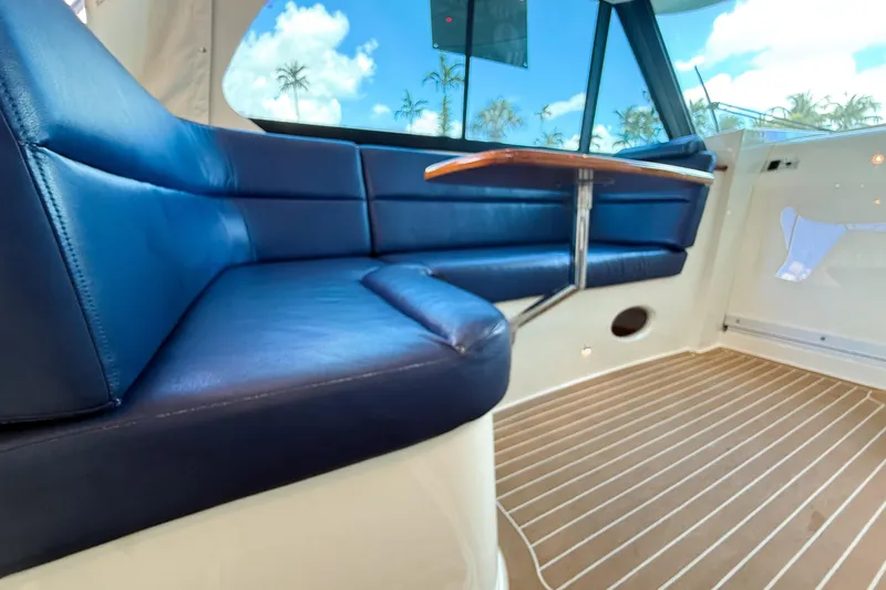  Yacht Photos Pics 2021 Hinckley Sport Boats 40x interior with blue seating and wooden flooring.