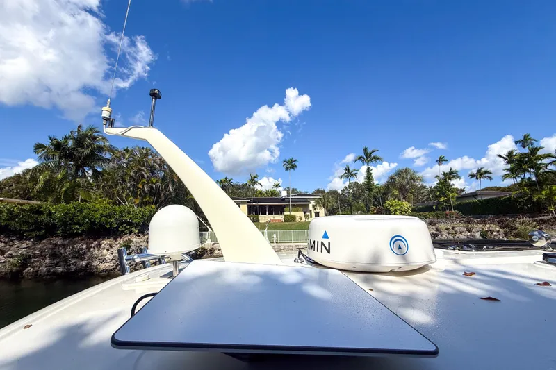  Yacht Photos Pics 2021 Hinckley Sport Boats 40x with Garmin equipment, docked near tropical landscape.