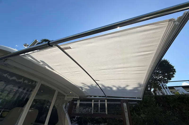  Yacht Photos Pics 2021 Hinckley Sport Boats 40x with extended sunshade under clear blue sky.