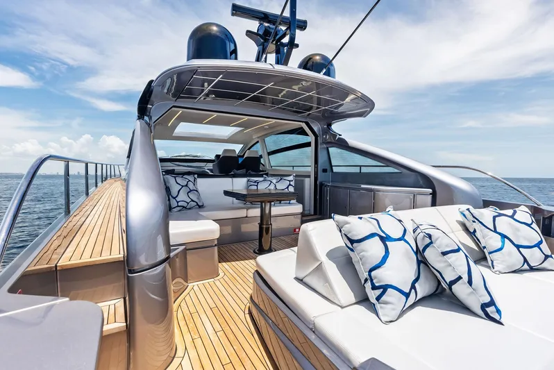 Our Trade Yacht Photos Pics Luxurious 2024 Pershing 6X yacht with elegant deck and stylish seating on open sea.