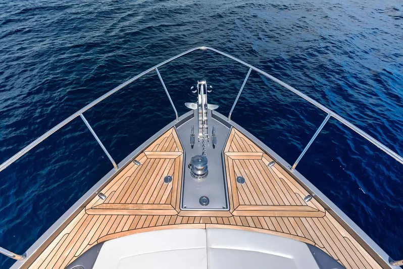 Our Trade Yacht Photos Pics Bow of 2024 Pershing 6X yacht with teak decking on open sea.