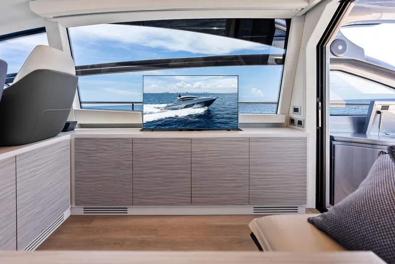Our Trade Yacht Photos Pics Luxurious interior of 2024 Pershing 6X yacht with ocean view and modern TV display.