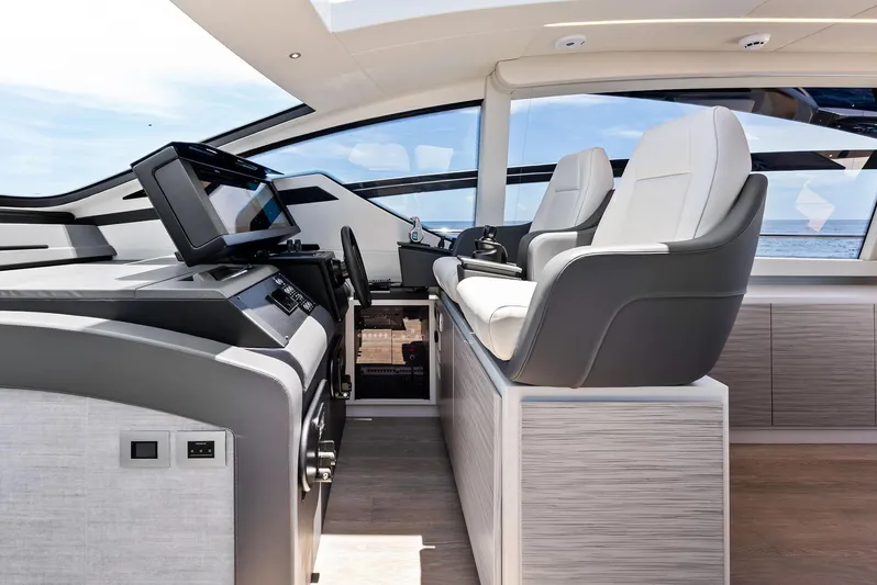 Our Trade Yacht Photos Pics Luxurious interior of 2024 Pershing 6X yacht with modern helm and seating.
