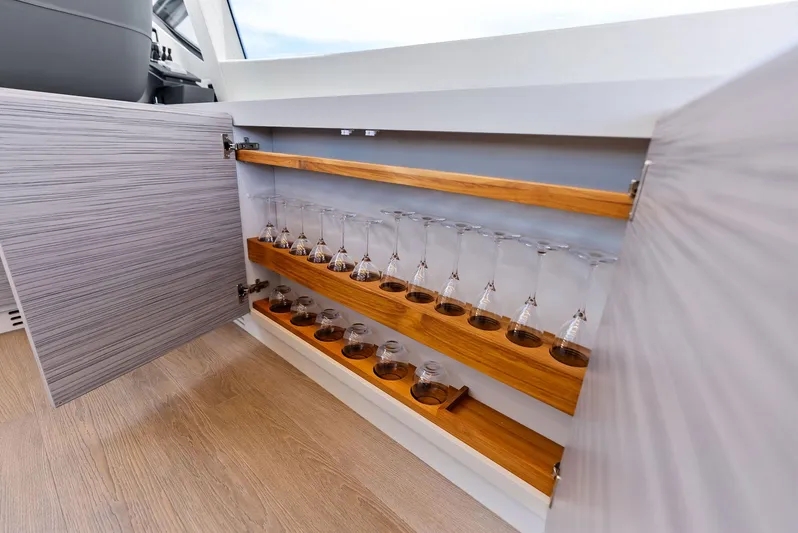 Our Trade Yacht Photos Pics Open cabinet with neatly arranged glassware on a Pershing 6X yacht, 2024 model.