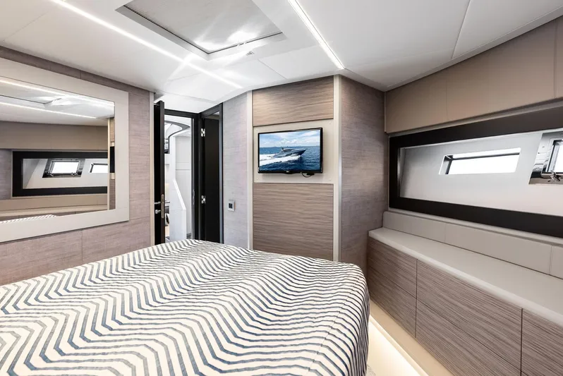 Our Trade Yacht Photos Pics Luxurious bedroom interior of 2024 Pershing 6X yacht with modern design and window view.